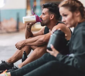 Atletas de alto rendimiento utilizando suplementos deportivos Herbalife24 para mejorar su recuperación muscular.