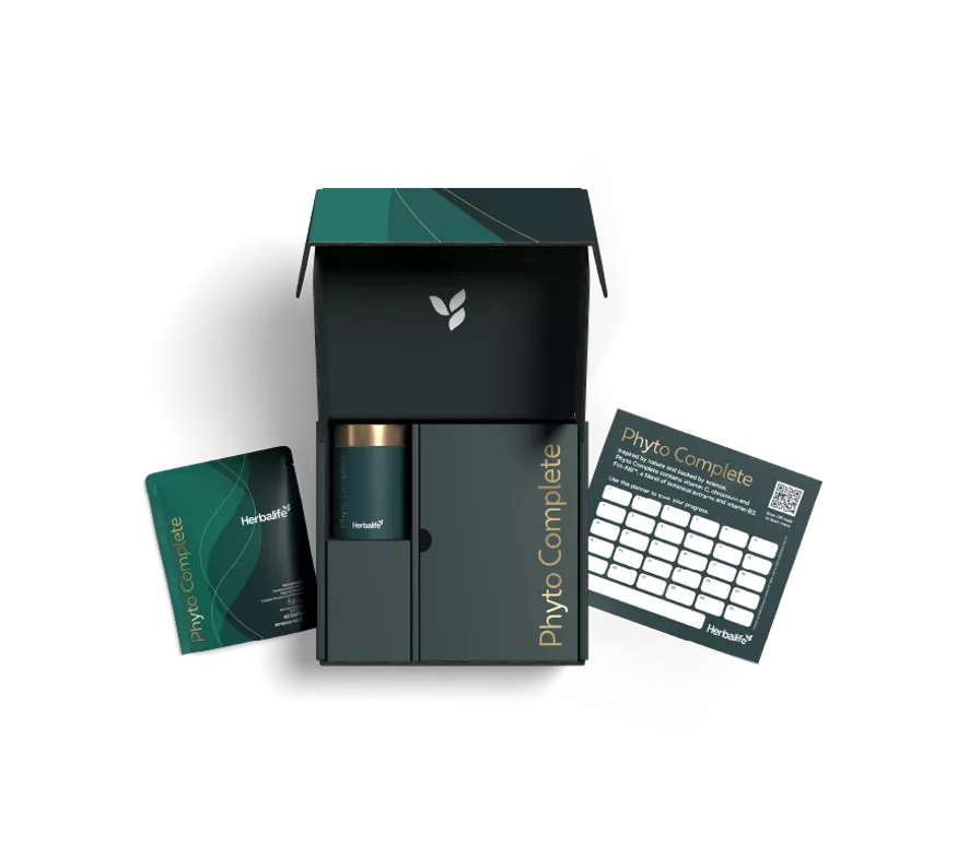 Caja abierta del Kit de inicio Phyto Complete de Herbalife con bote premium, sobre de cápsulas y tabla de progreso.